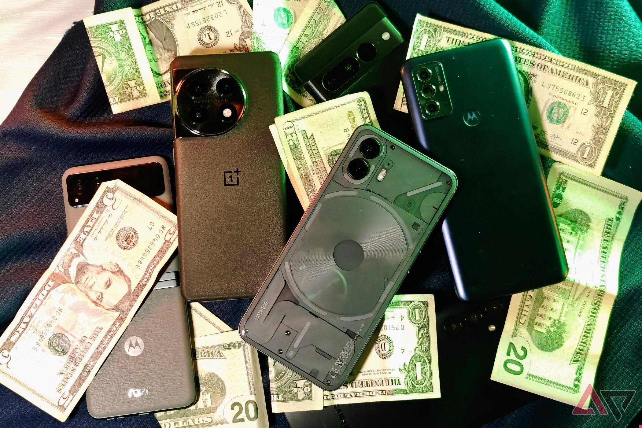 Nothing Phone 2, Pixel 7 Pro, Motorla Razr, OnePlus 11, and more smartphones on a table with cash