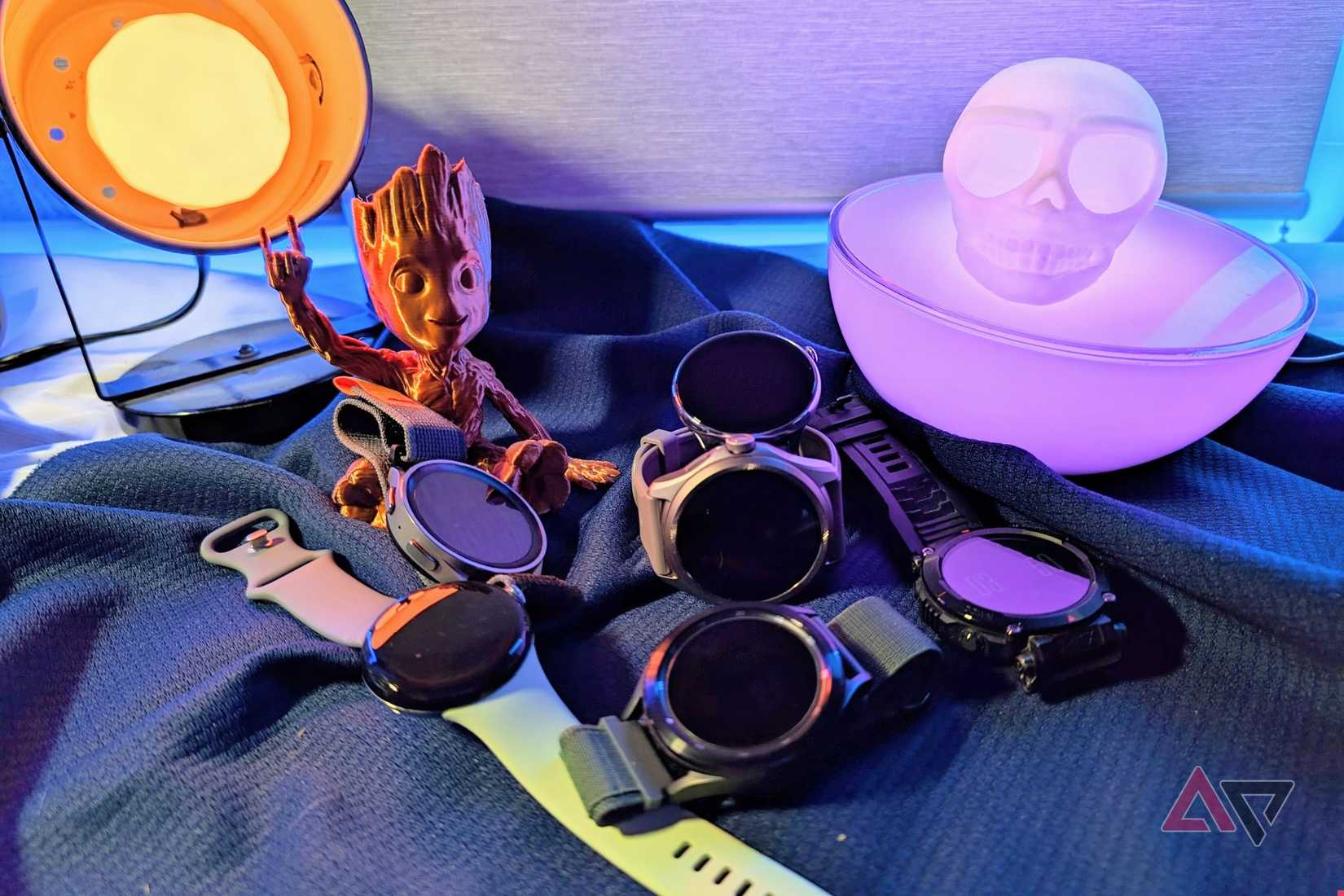 Samsung Galaxy Watch Pro5, TicWatch Pro 5, Google Pixel Watch, and other smartwatches on a table with colored lights