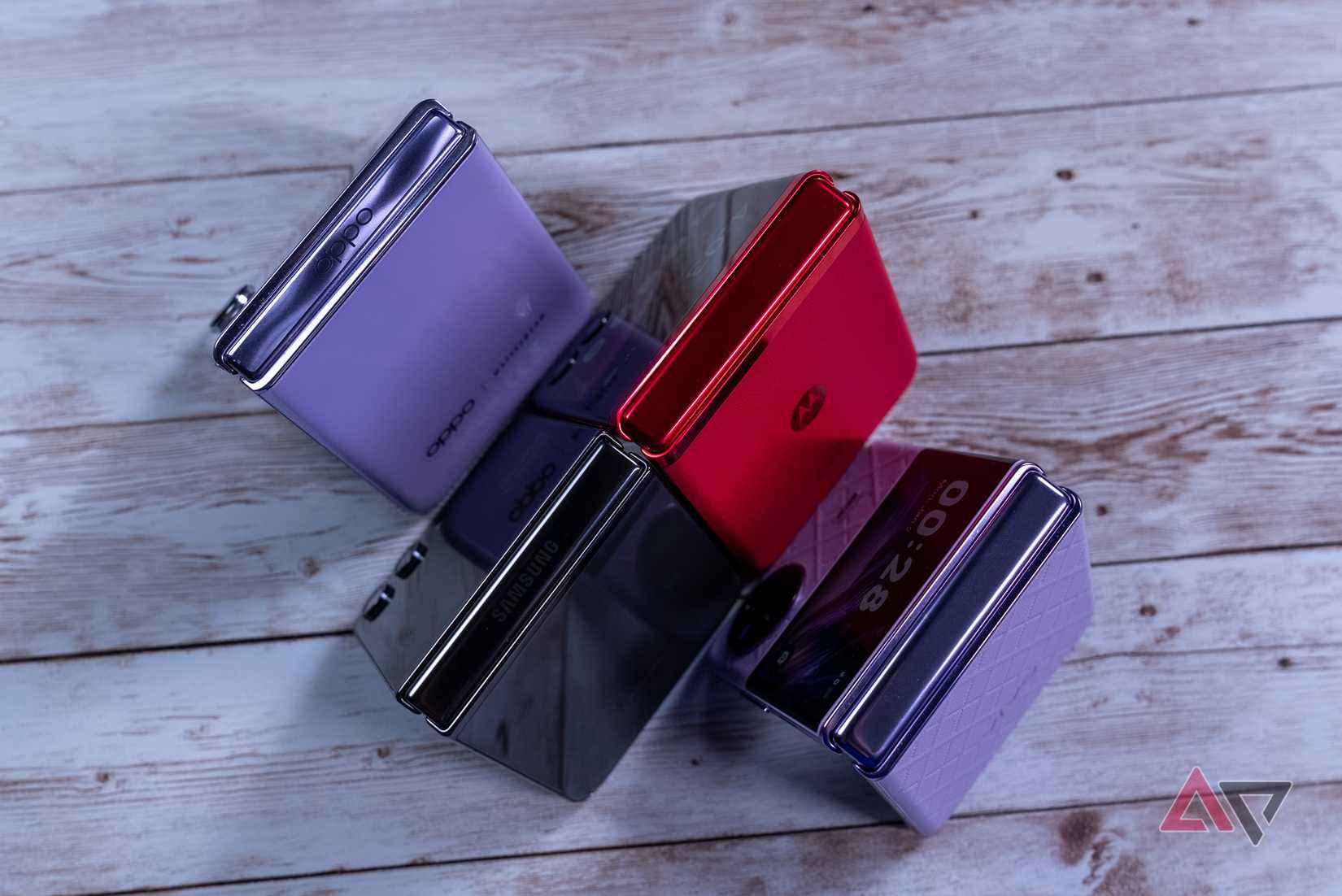 Motorola Razr+, Galaxy Z Flip 5, Vivo X Flip and OPPO Find N3 Flip on a table half folded