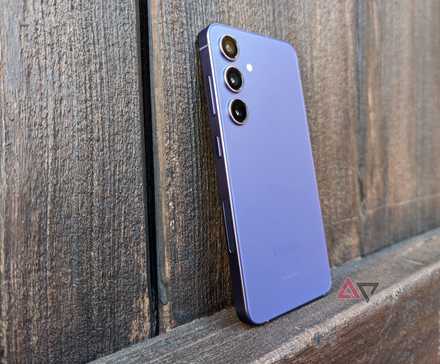 The Samsung Galaxy S24 leaning on a wooden door