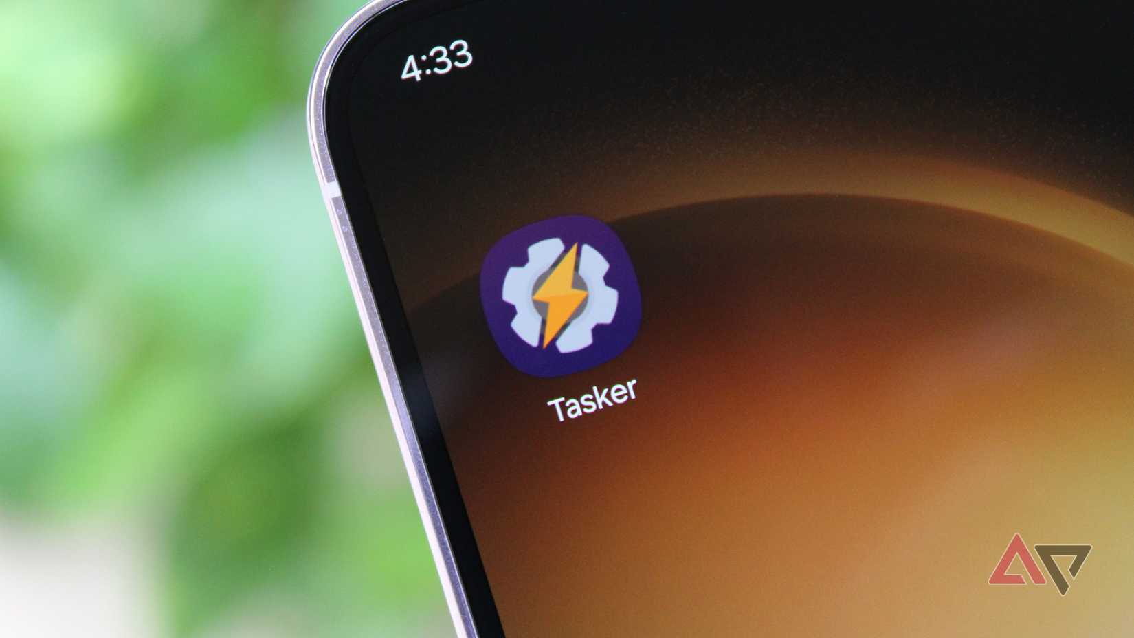 Photo of the Tasker app's icon on a phone's home screen, close-cropped against a green background