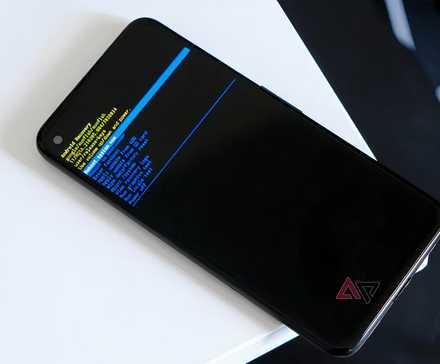 A phone in Android Recovery Mode atop a white table.