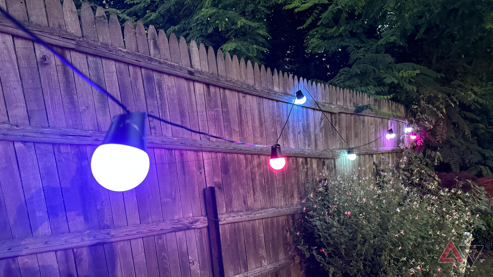 Govee Outdoor String Lights 2 lit up and placed on a fence