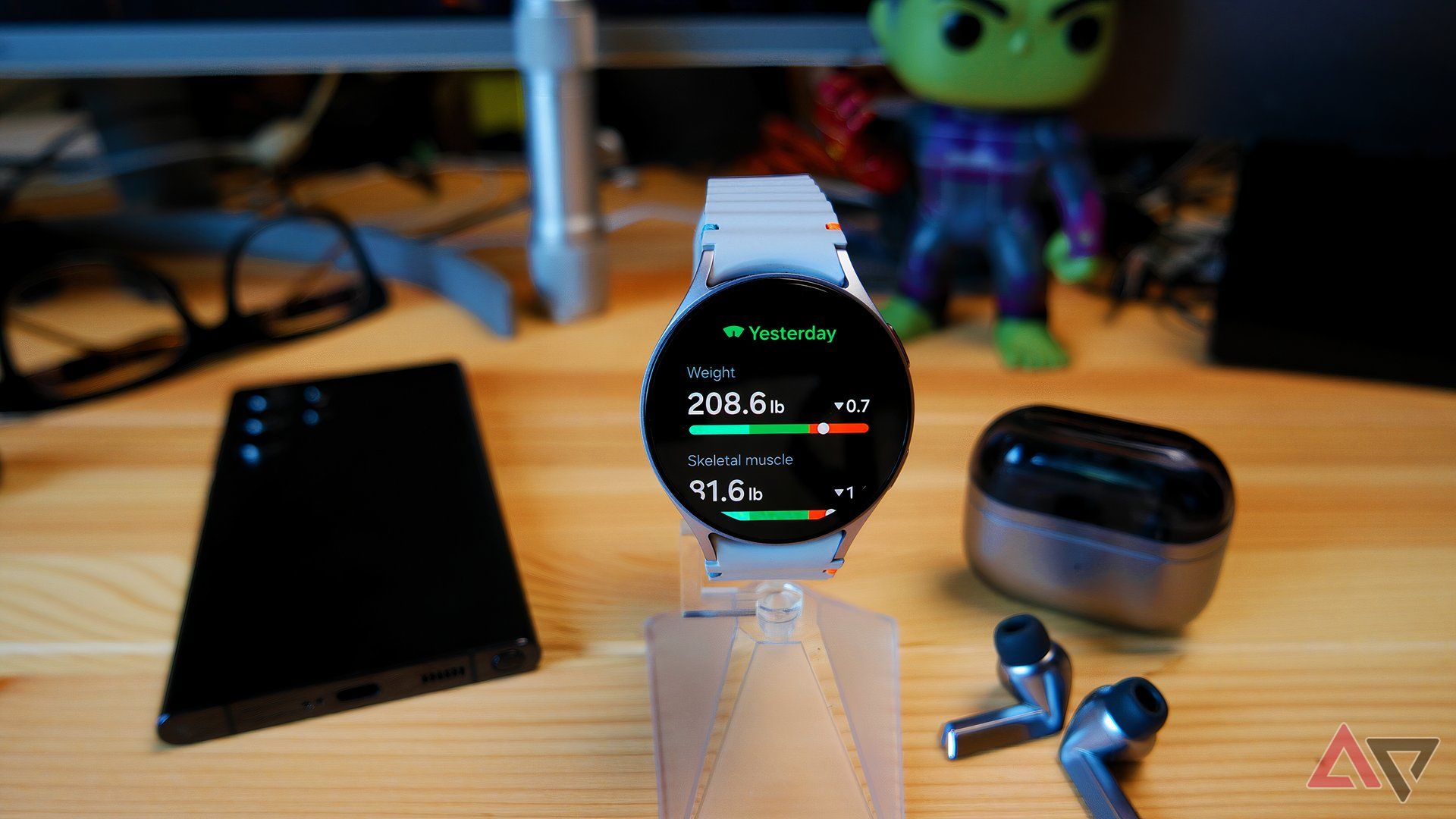 Samsung Galaxy Watch 7 on a watch stand, showing body composition data