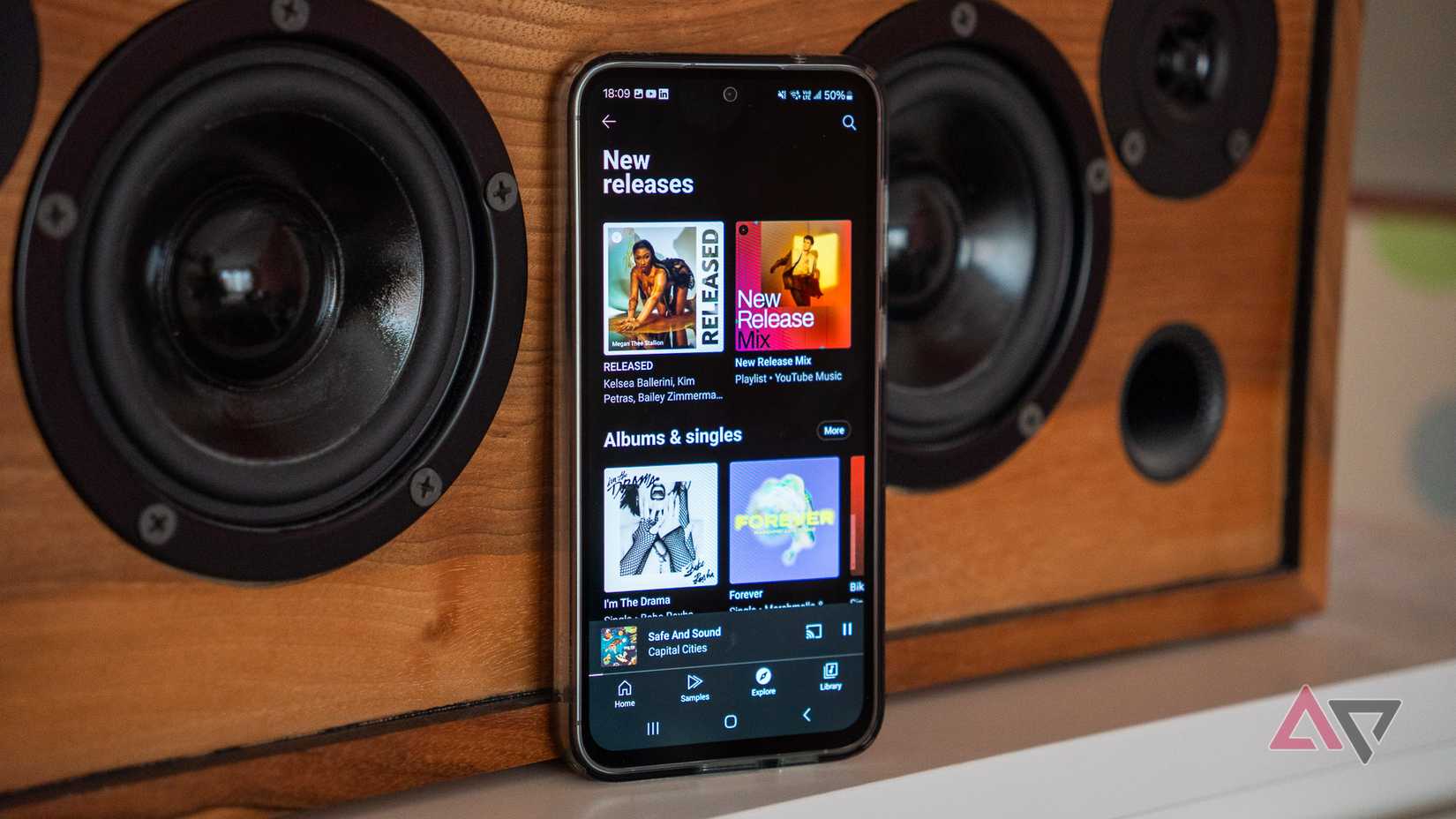 YouTube Music Premium On A Samsung Phone Propped Up Against A Speaker
