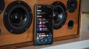 YouTube Music Premium On A Samsung Phone Propped Up Against A Speaker