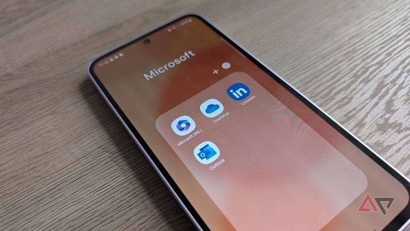 android phone showing microsoft apps on wood surface