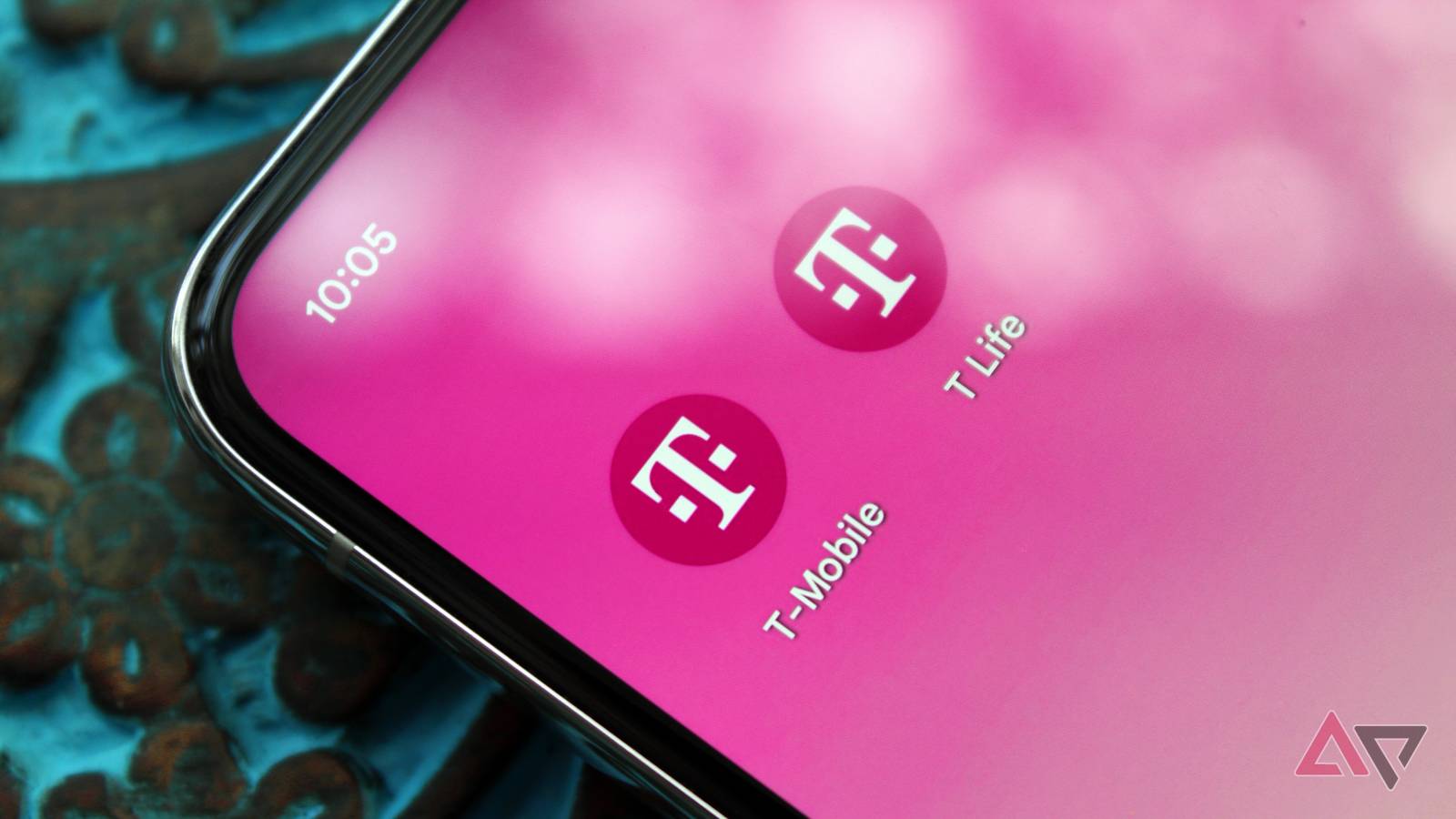 Photo of a phone with the T-Mobile app and T Life app on its home screen.