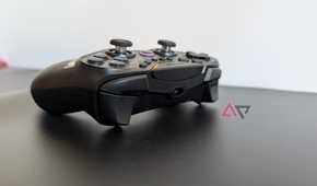 black gamesir controller resting on black surface showing bumpers and triggers