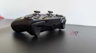 black gamesir controller resting on black surface showing bumpers and triggers