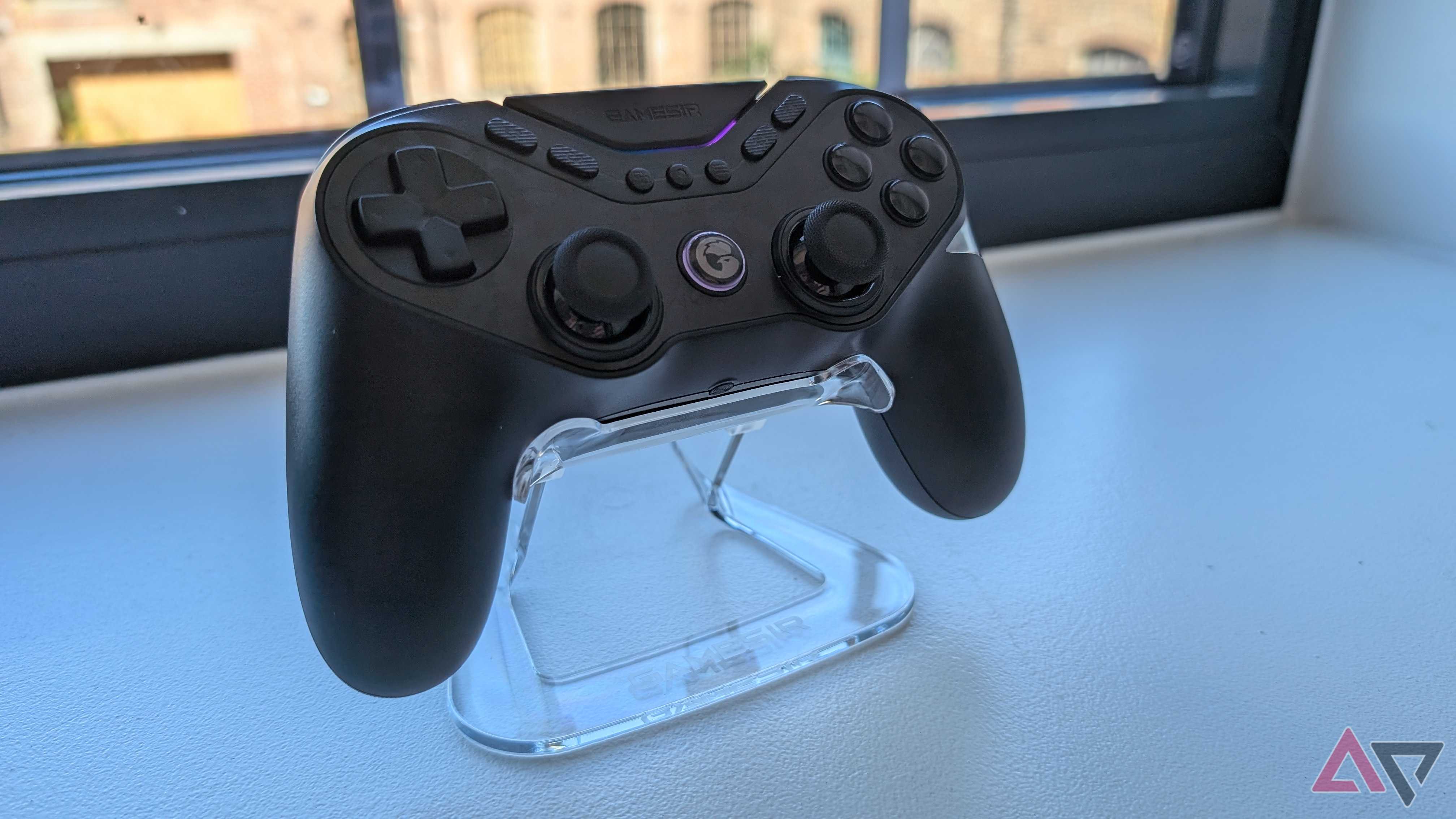 black gamesir controller resting on clear plastic stand