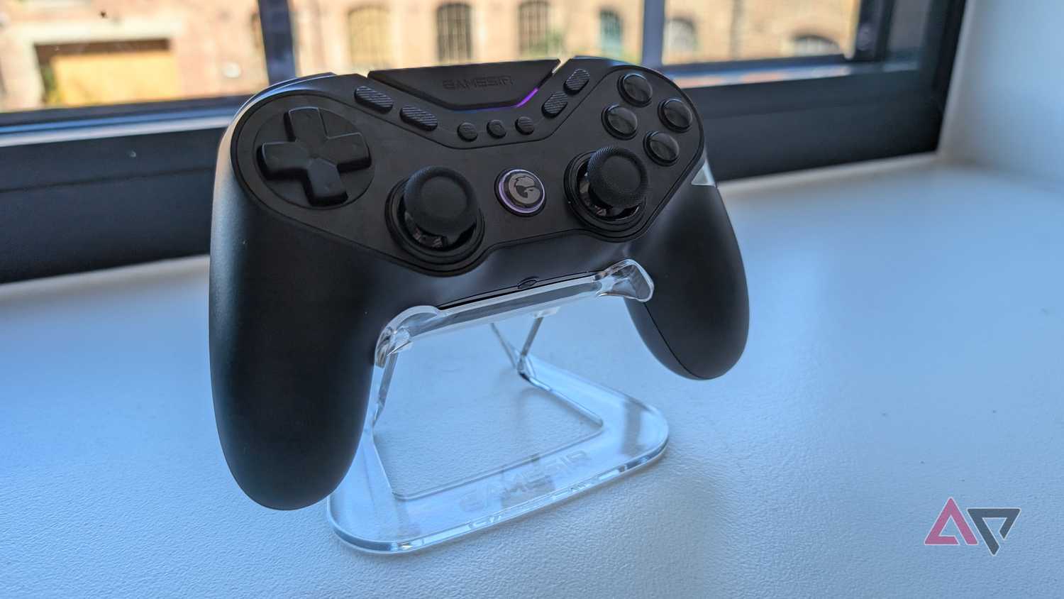 black gamesir controller resting on clear plastic stand