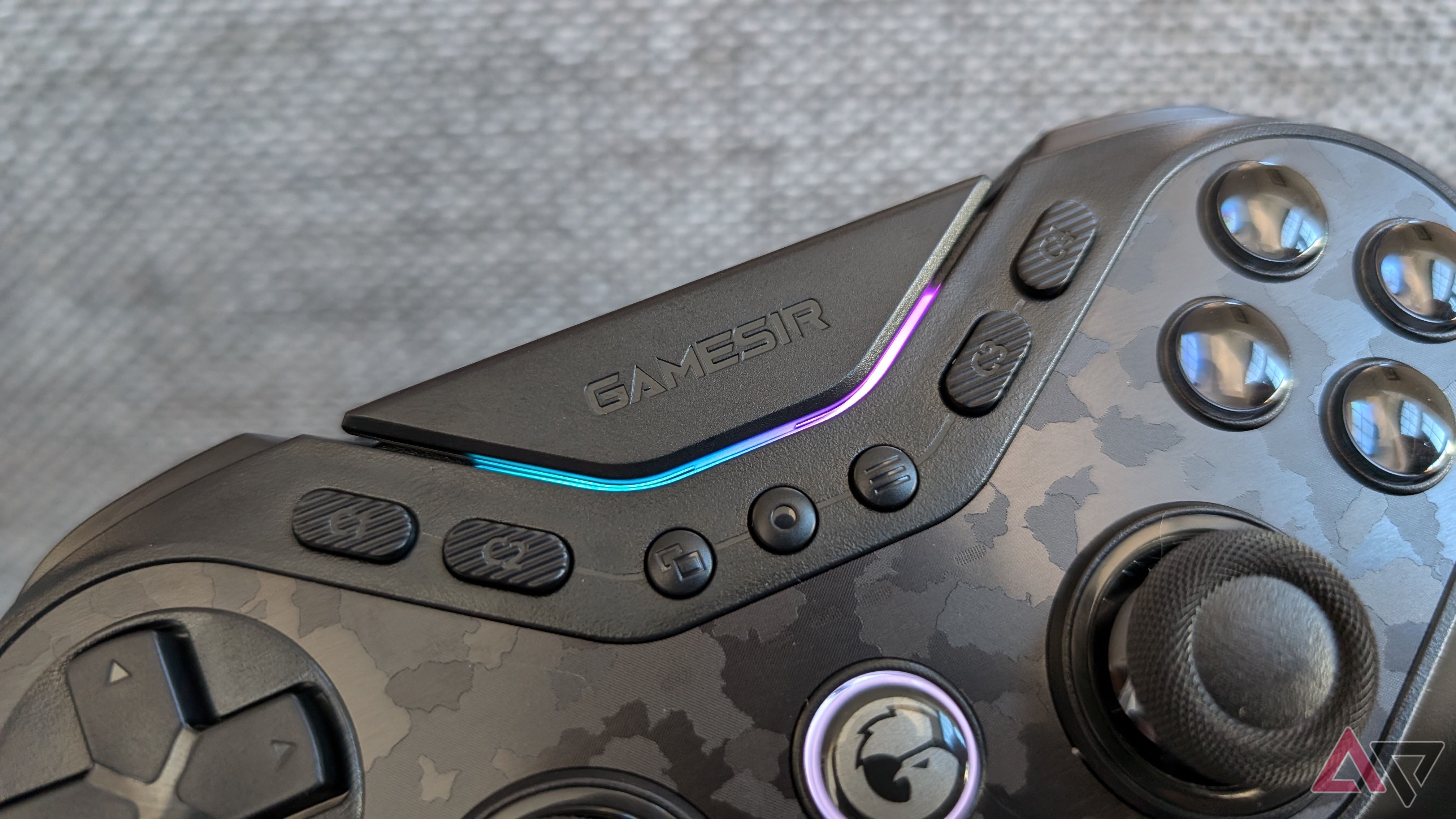 face buttons and blue and pink LEDs on black gamesir controller