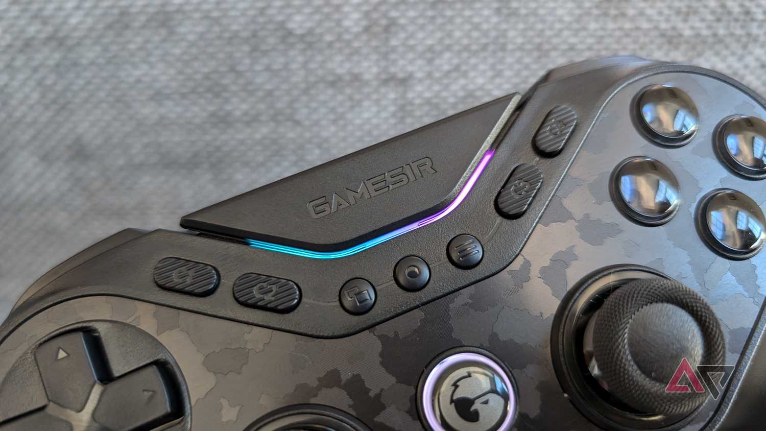 face buttons and blue and pink LEDs on black gamesir controller