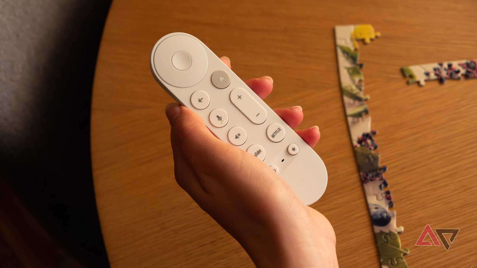 The Google TV Streamer remote in a woman's hand.