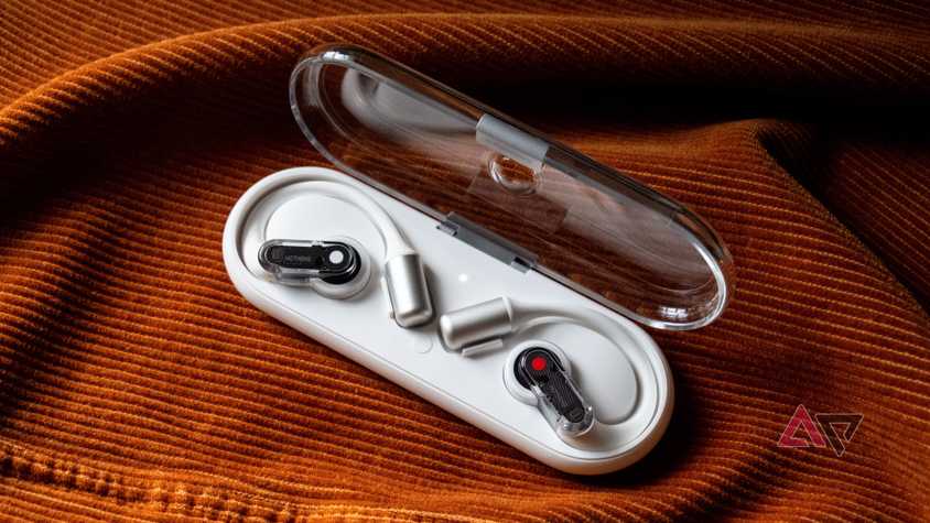 Earphones are in the case of an orange background.