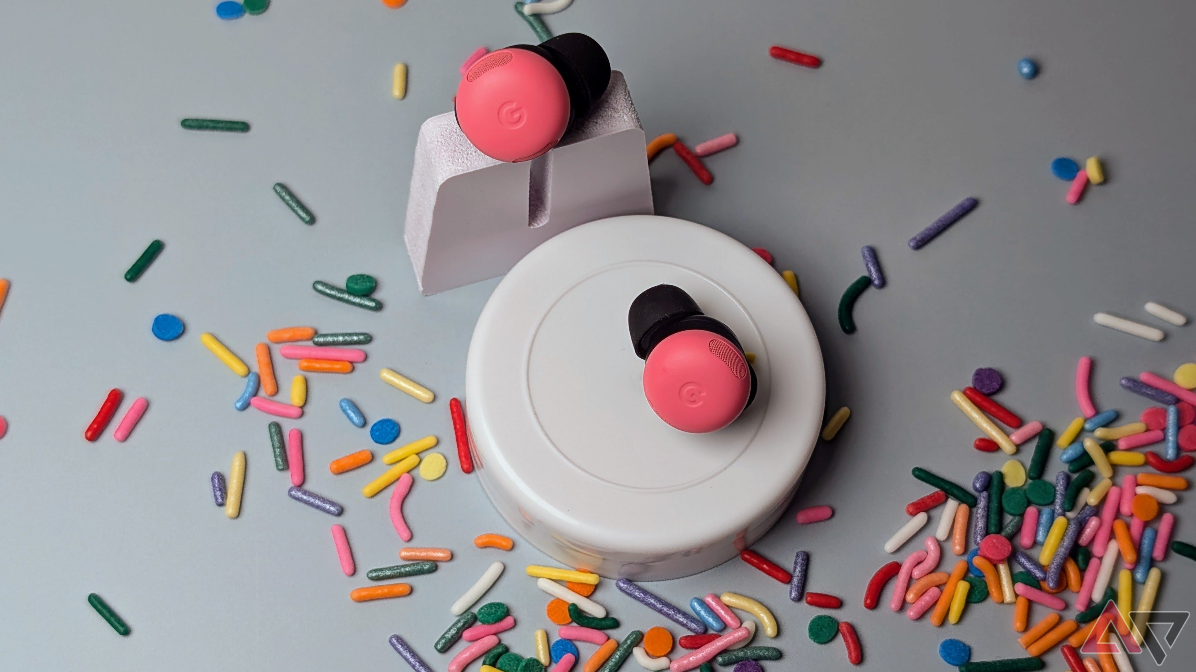 Peony Pixel Buds Pro 2 set on white stands surrounded by sprinkles