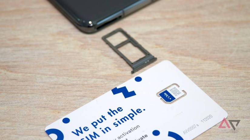 A phone with its SIM tray out with a Visible SIM besides it.