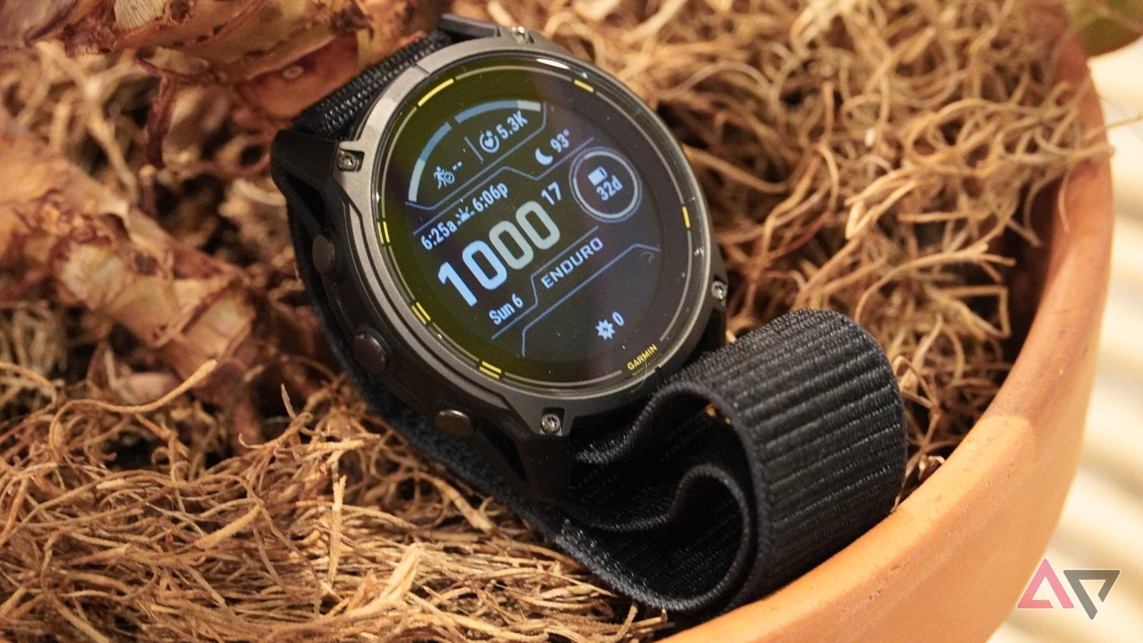 A close-up of the Garmin Enduro 3 resting in a pot.