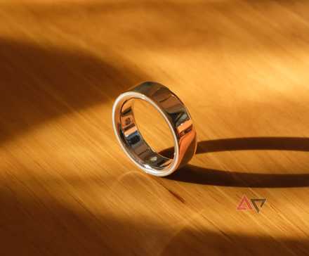 A smart ring standing on edge on a desk.