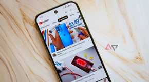 A phone with the YouTube Premium app sits atop an unfinished wood plank.