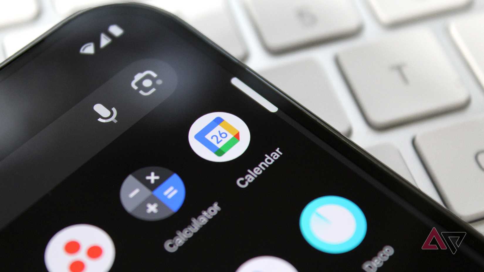 The Google Calendar app shown on a phone's screen with a keyboard visible in the background.