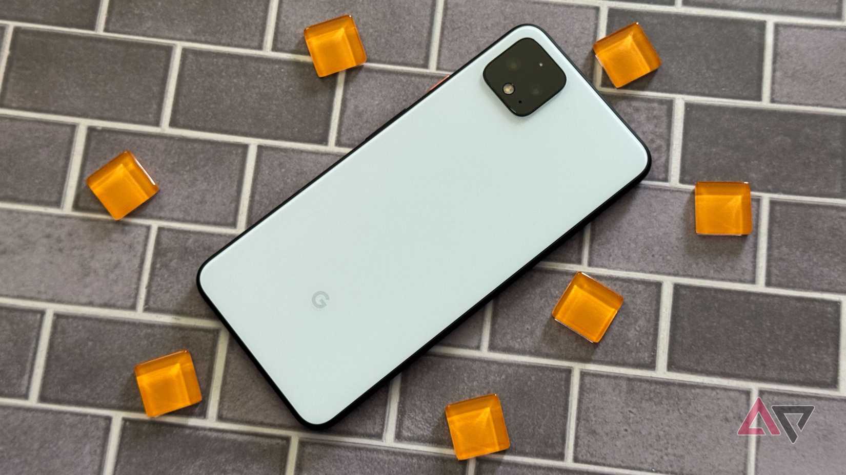 The Google Pixel 4 XL in white, face-down on a brick surface.