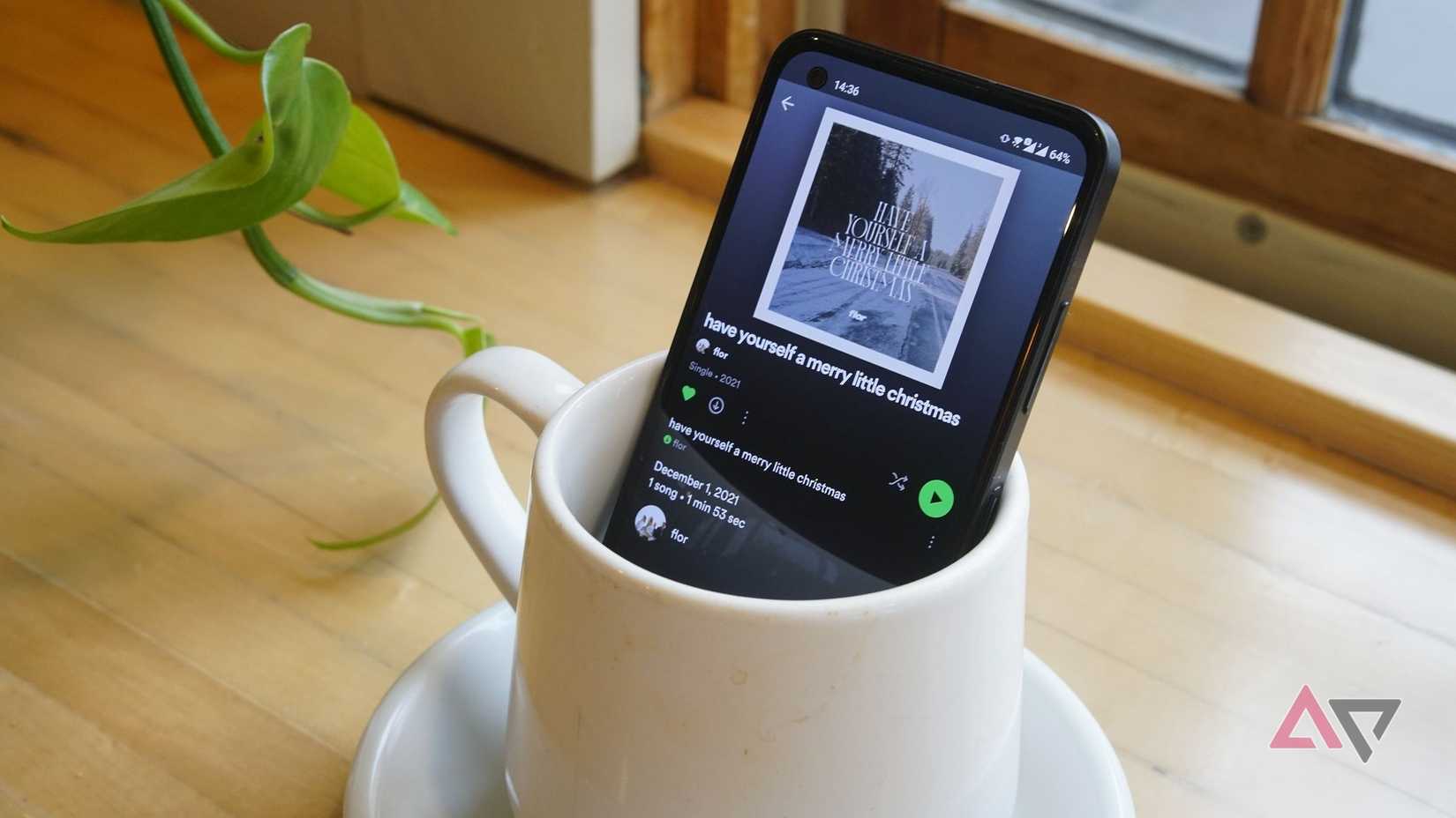 spotify on phone screen as phoe sits in coffee cup