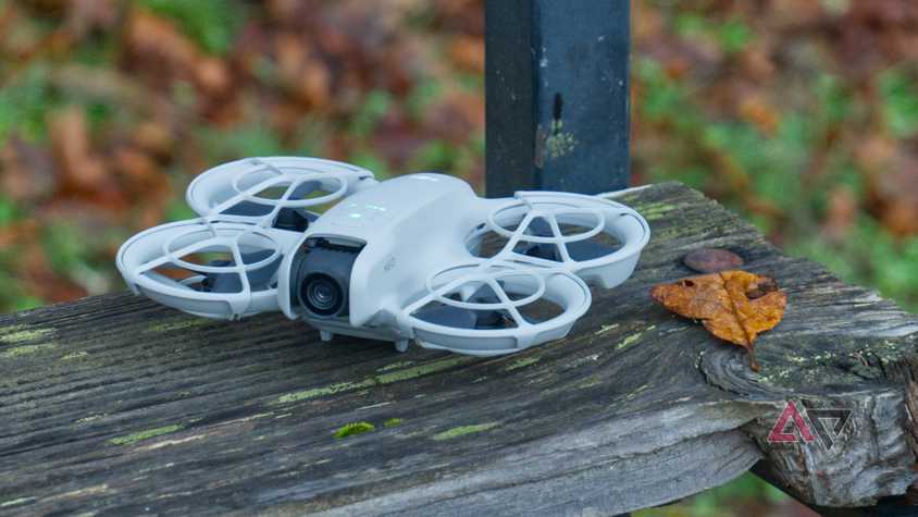 Dji Neo on a wooden bench next to the paper
