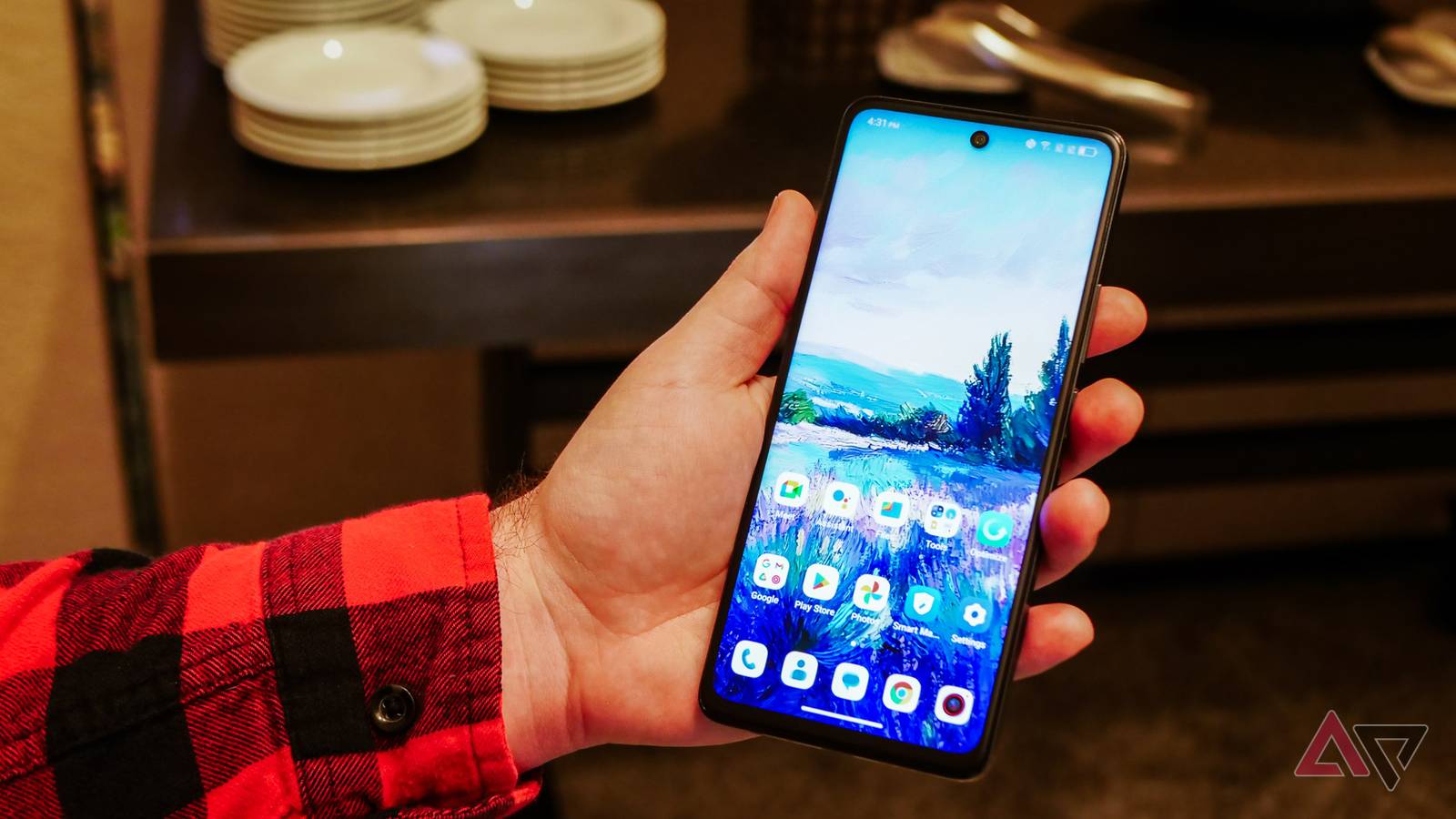 A hand holding a smartphone.