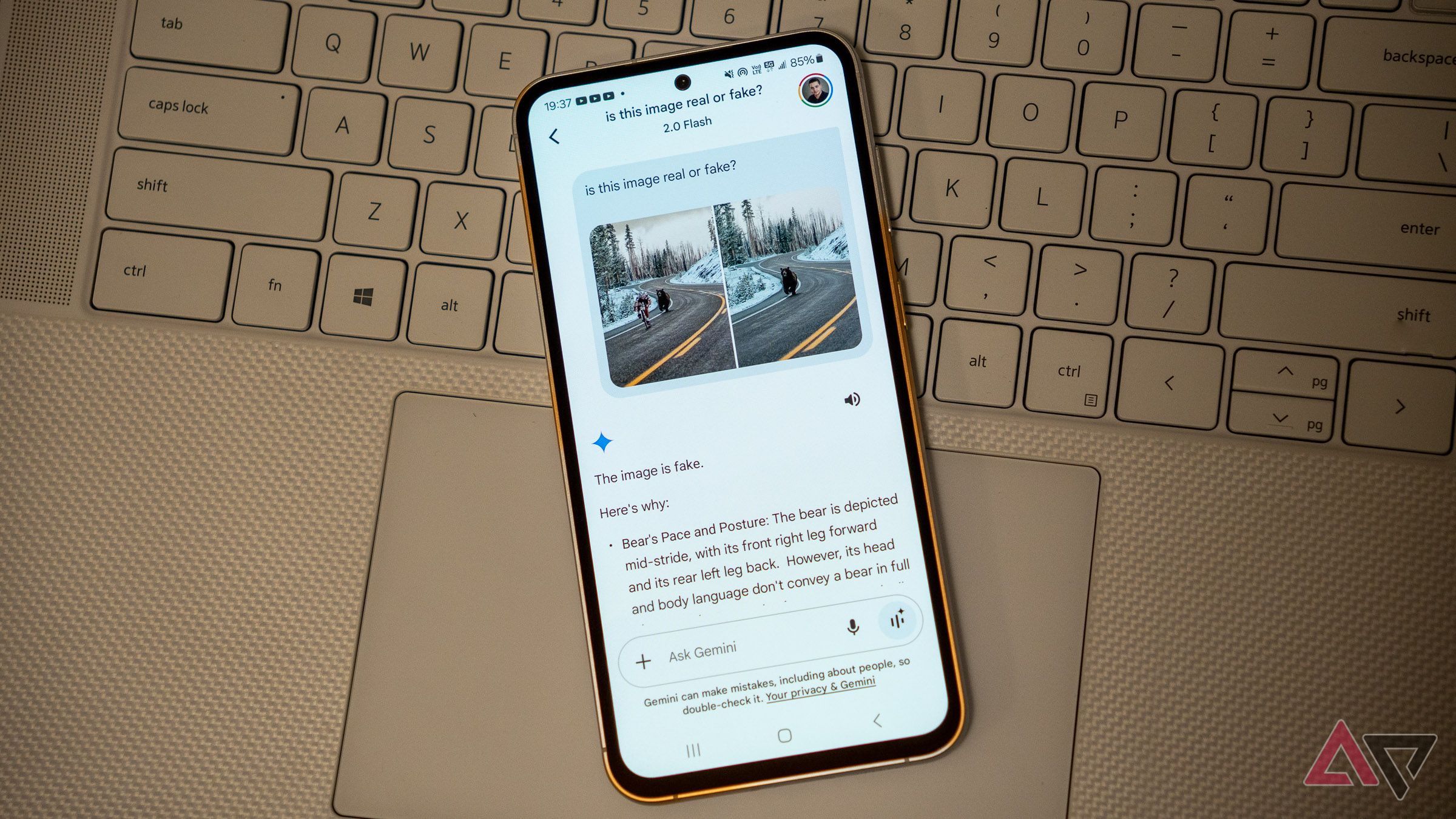 a samsung galaxy phone on a laptop keyboard with google gemini app opened