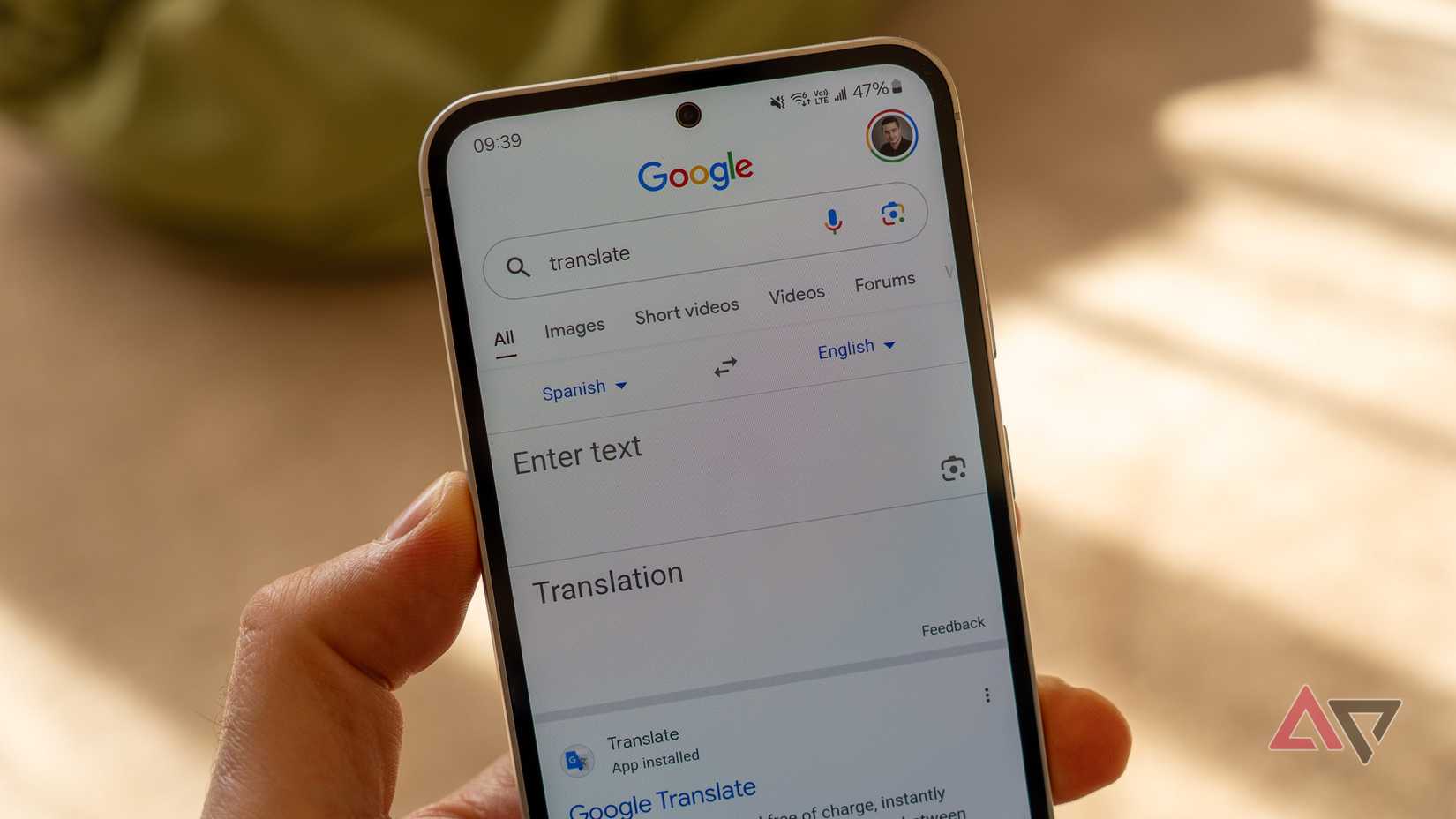 a phone in hand displaying a google translate screen