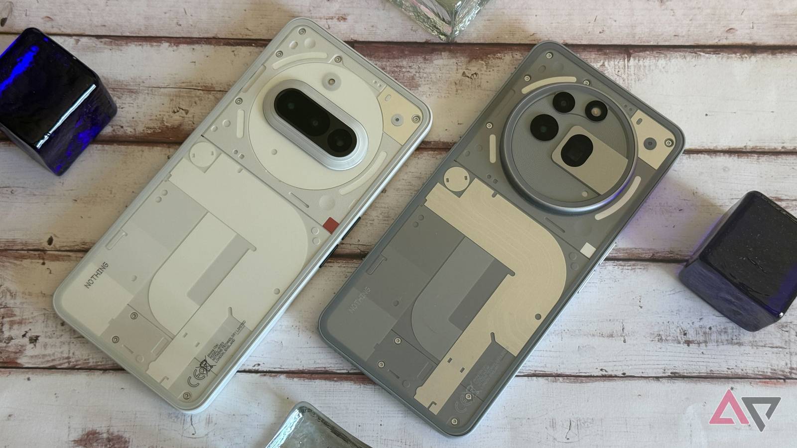 The Nothing Phone 3a and 3a Pro sitting next to each other on a desk.