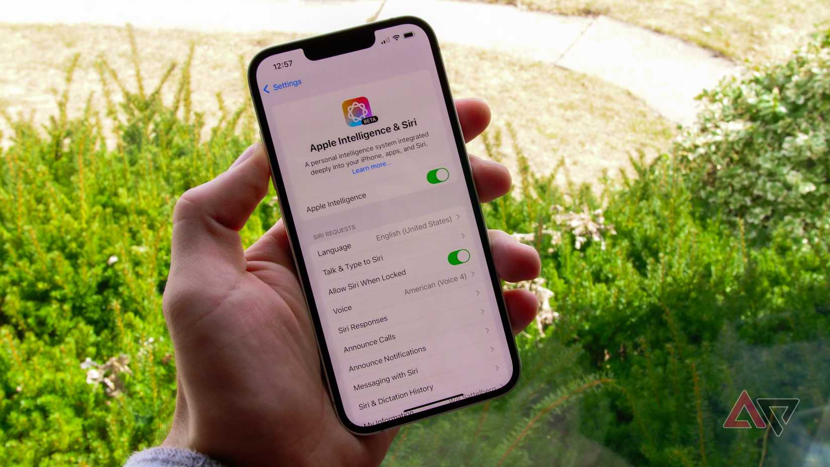 The iPhone 16e in a hand showing the Apple Intelligence menu
