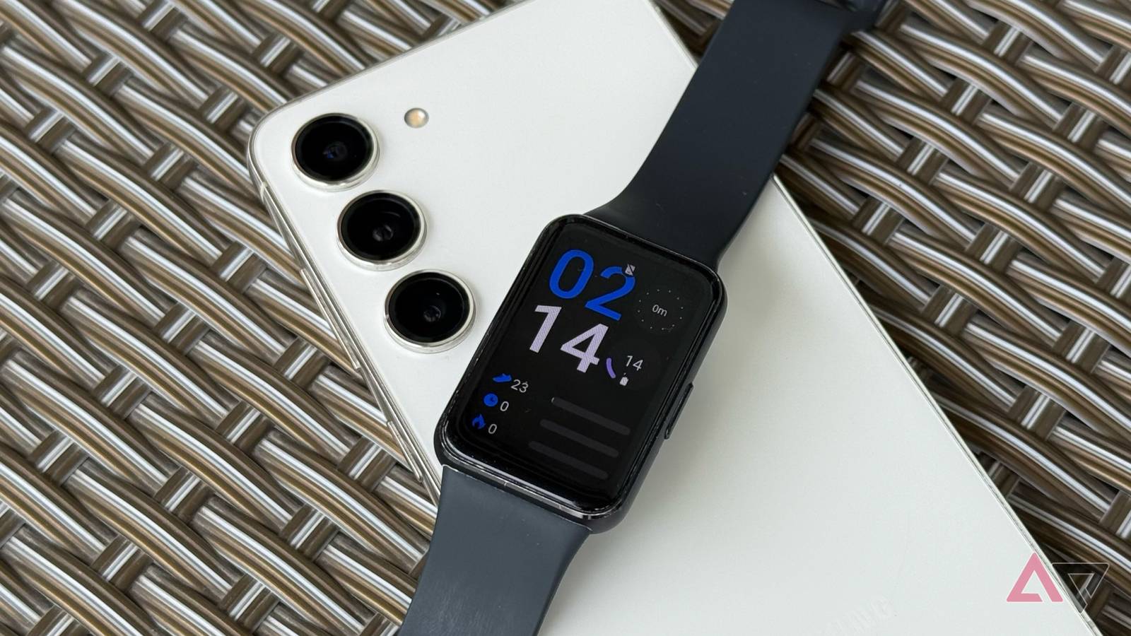 Samsung Galaxy Fit 3 on top of a Samsung Galaxy S23 showing home screen