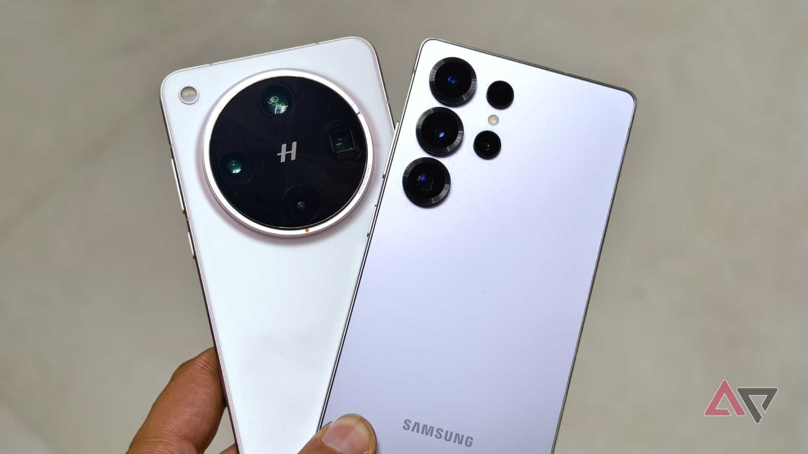 Samsung Galaxy S25 Ultra and Oppo Find X8 Ultra in hand, highlighting the rear camera designs