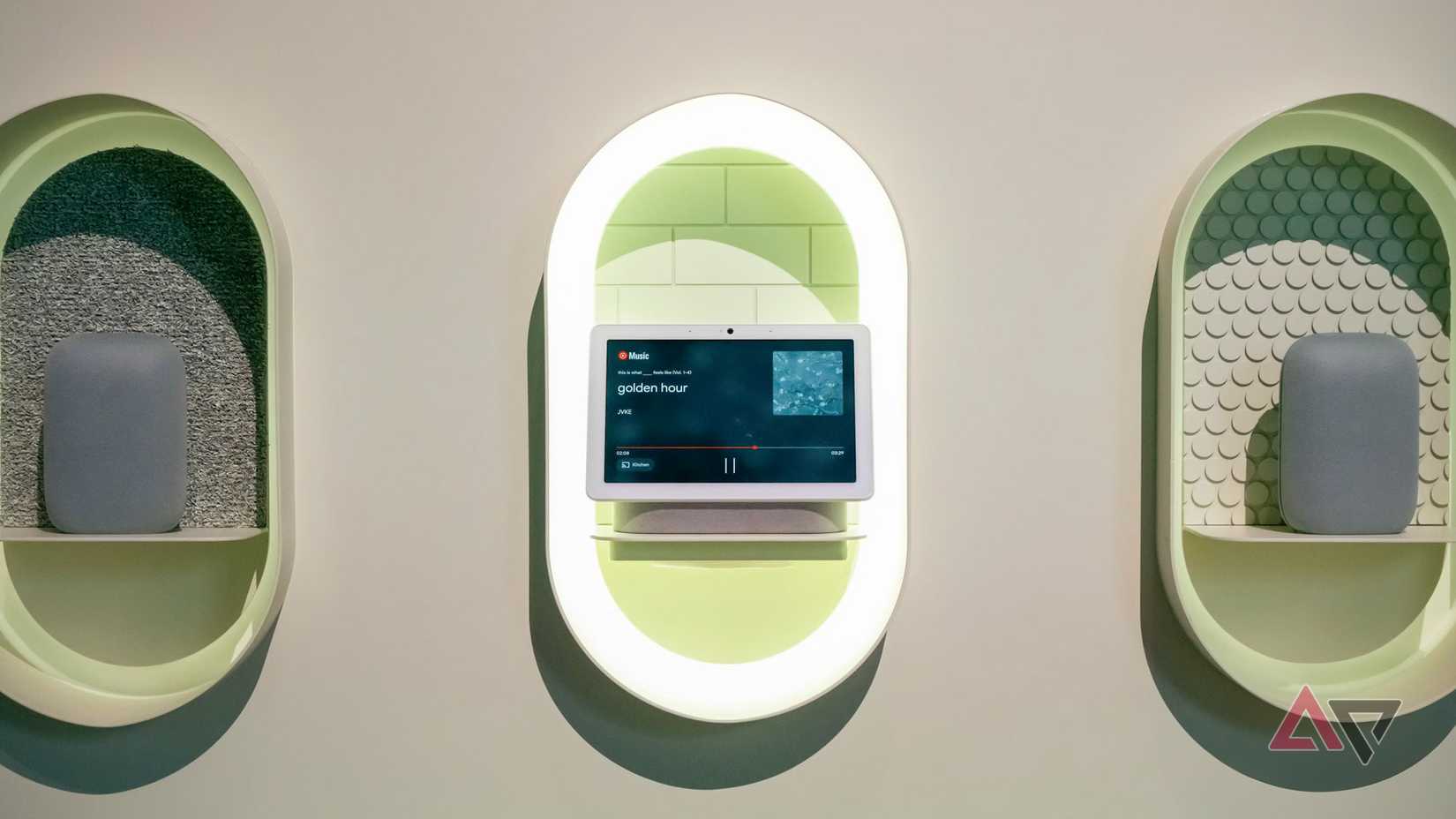 The Nest Hub Max and Nest Audio speakers displayed on a wall.