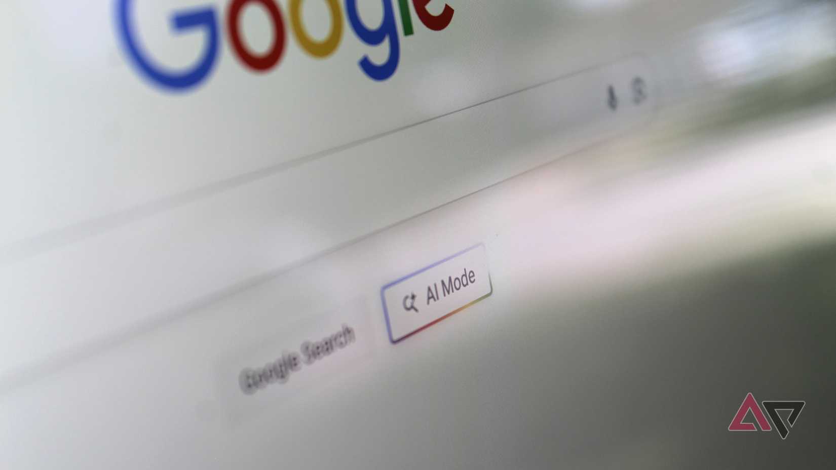 Photo of the AI Mode button on the Google Search home screen, shown on a computer monitor.