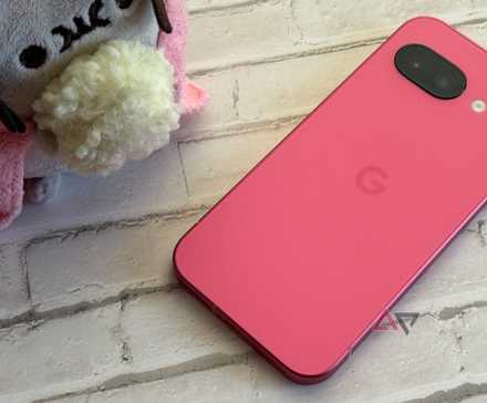 Google Pixel 9a in peony sitting next to a Pusheen with popcorn