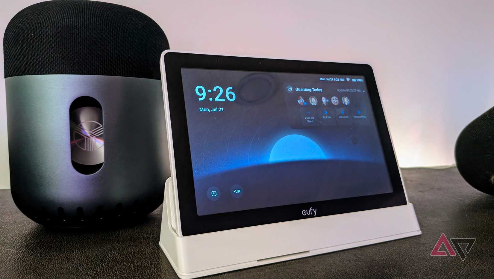 Eufy Smart Display E10 in its dock next to a Bluetooth speaker