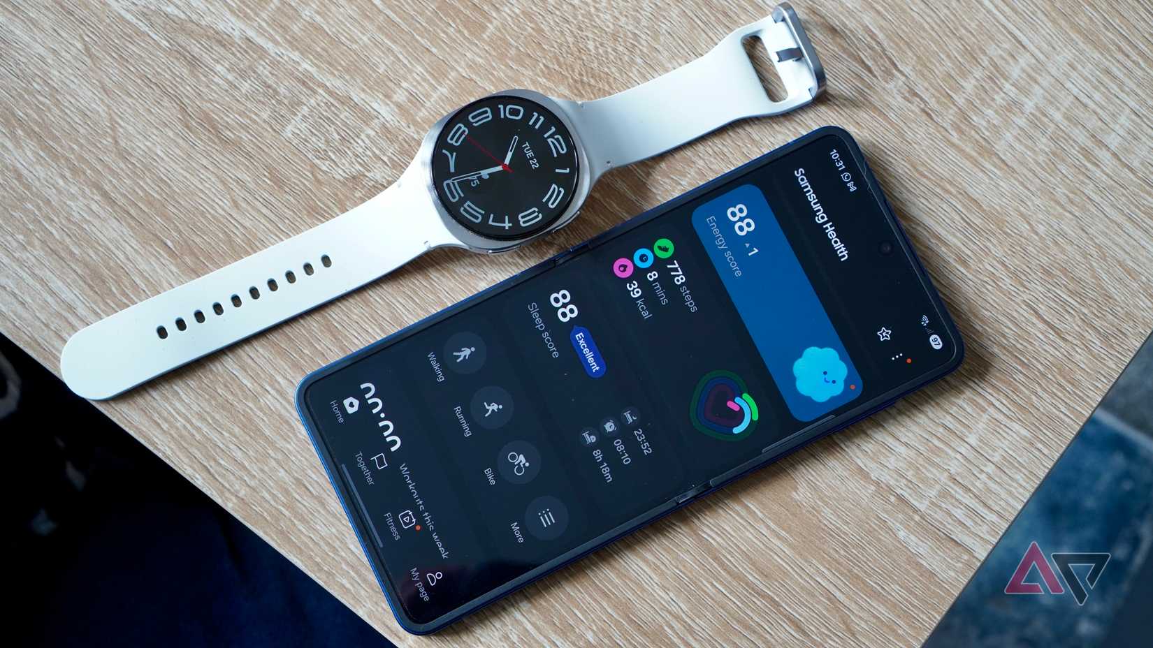 a galaxy watch 8 displayed next to a phone with Samsung Health app opened