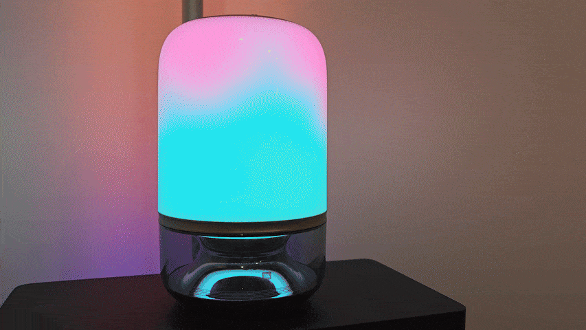 The Govee Table Lamp 2 Pro x Sound from JBL shows a color-changing light with a glowing light behind it.
