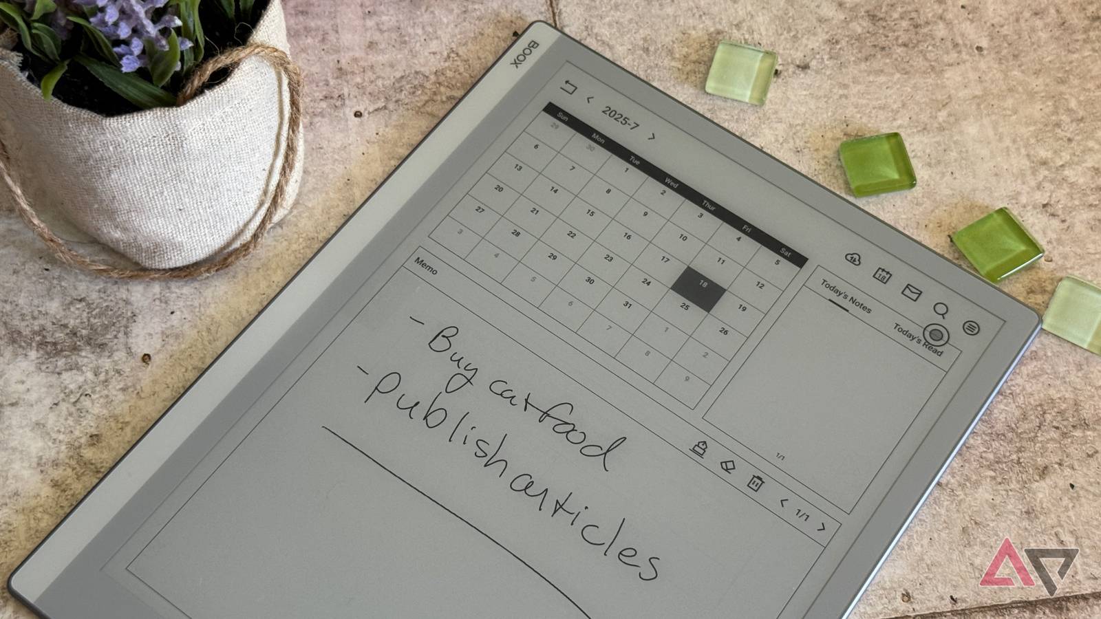 Onyx Boox Go 10.3 surrounded by green glass beads