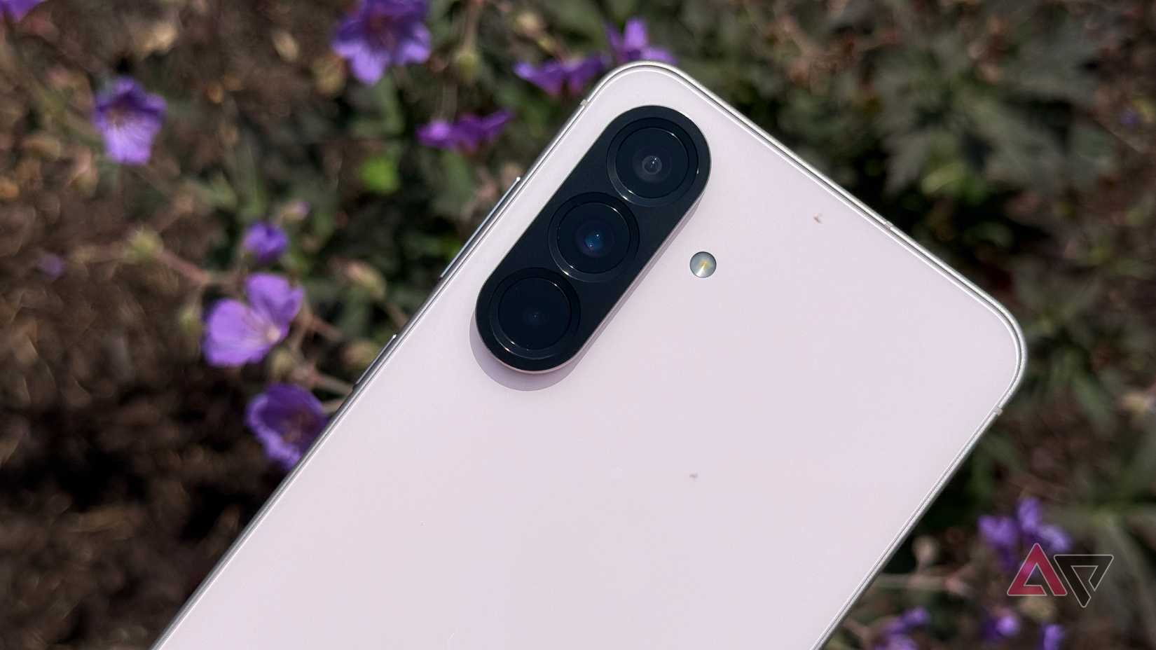 Samsung Galaxy A56 set against purple flowers