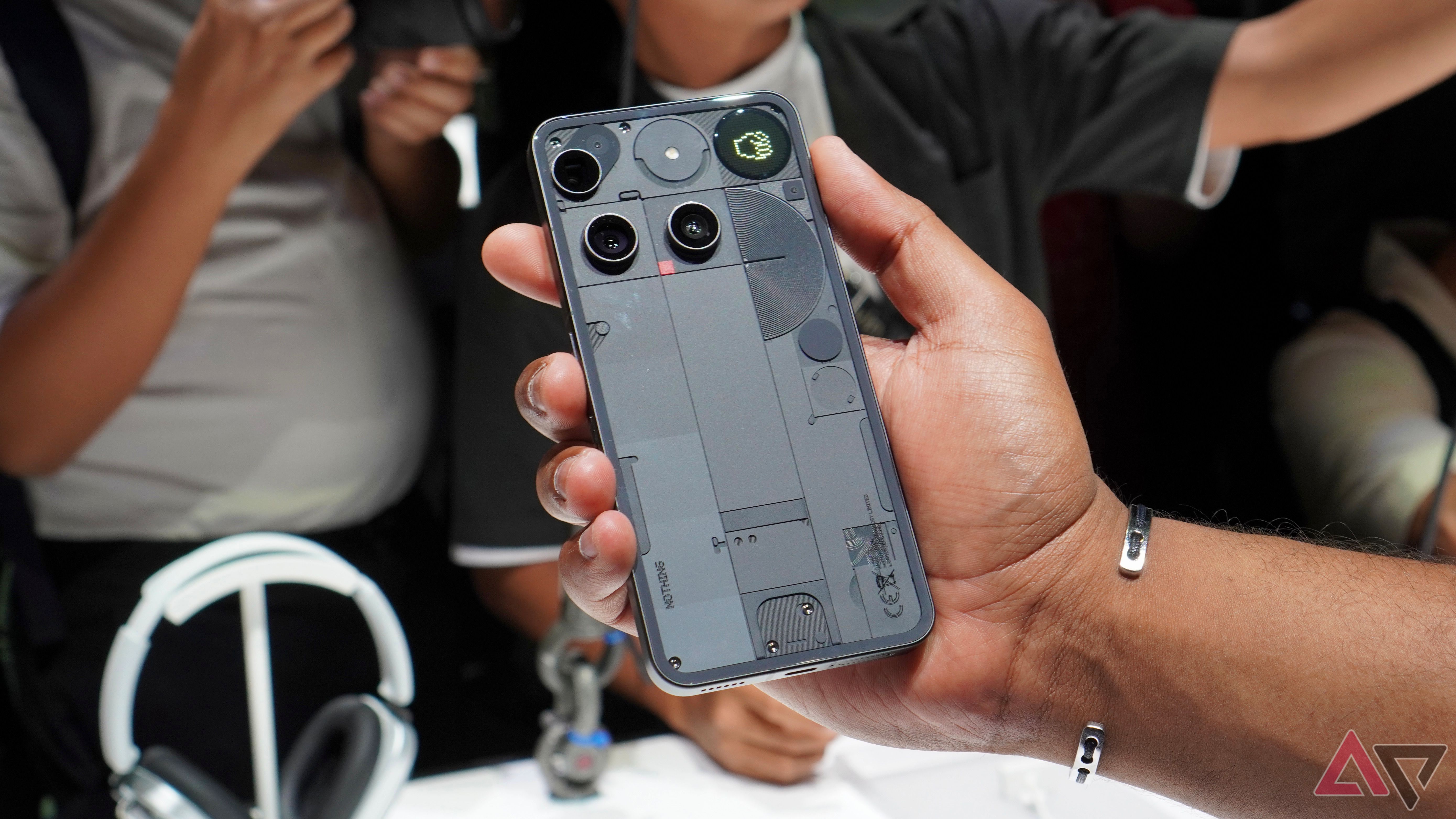 A person holding the black Nothing Phone 3