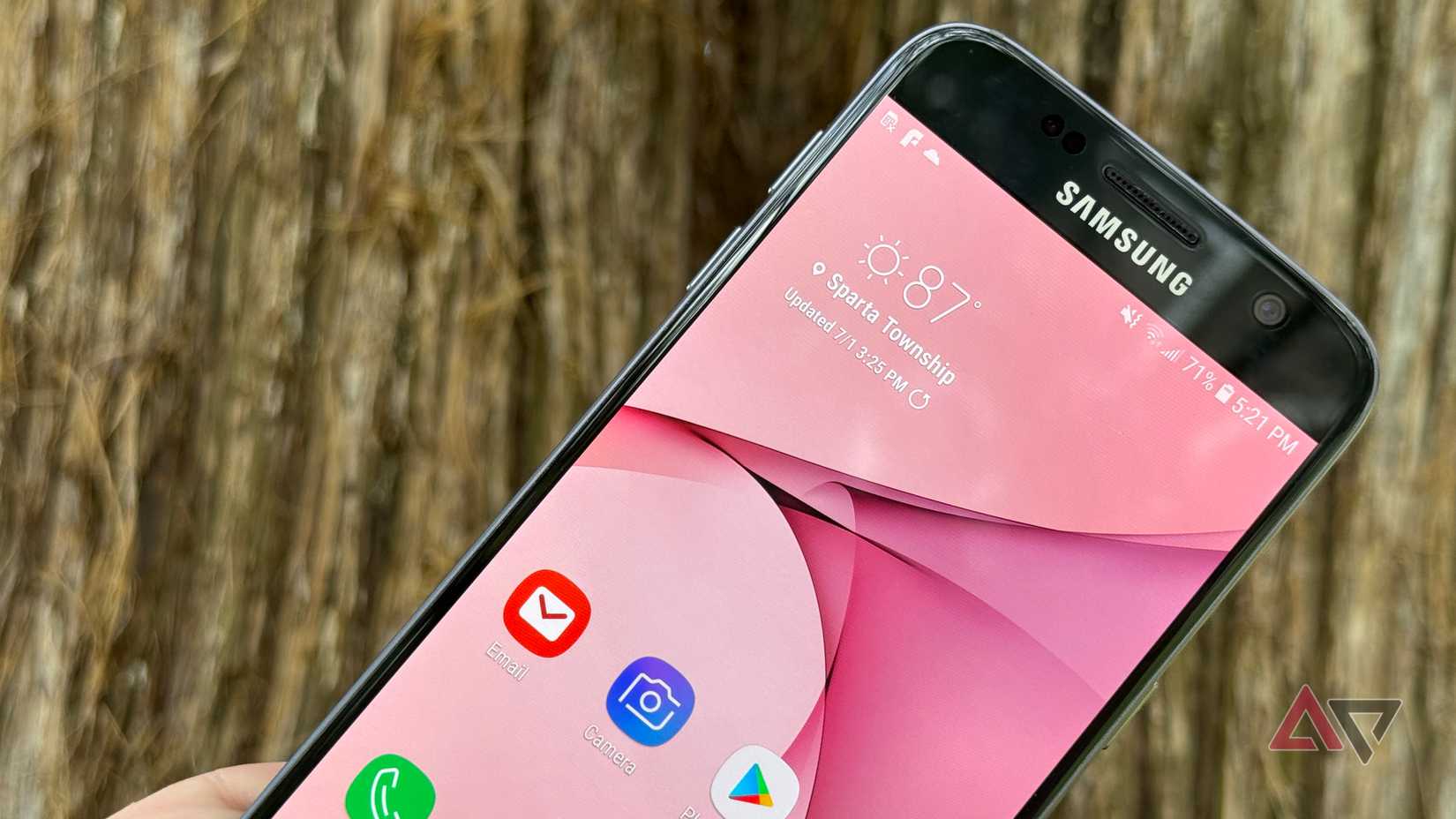 Samsung Galaxy S7 held up against a tree
