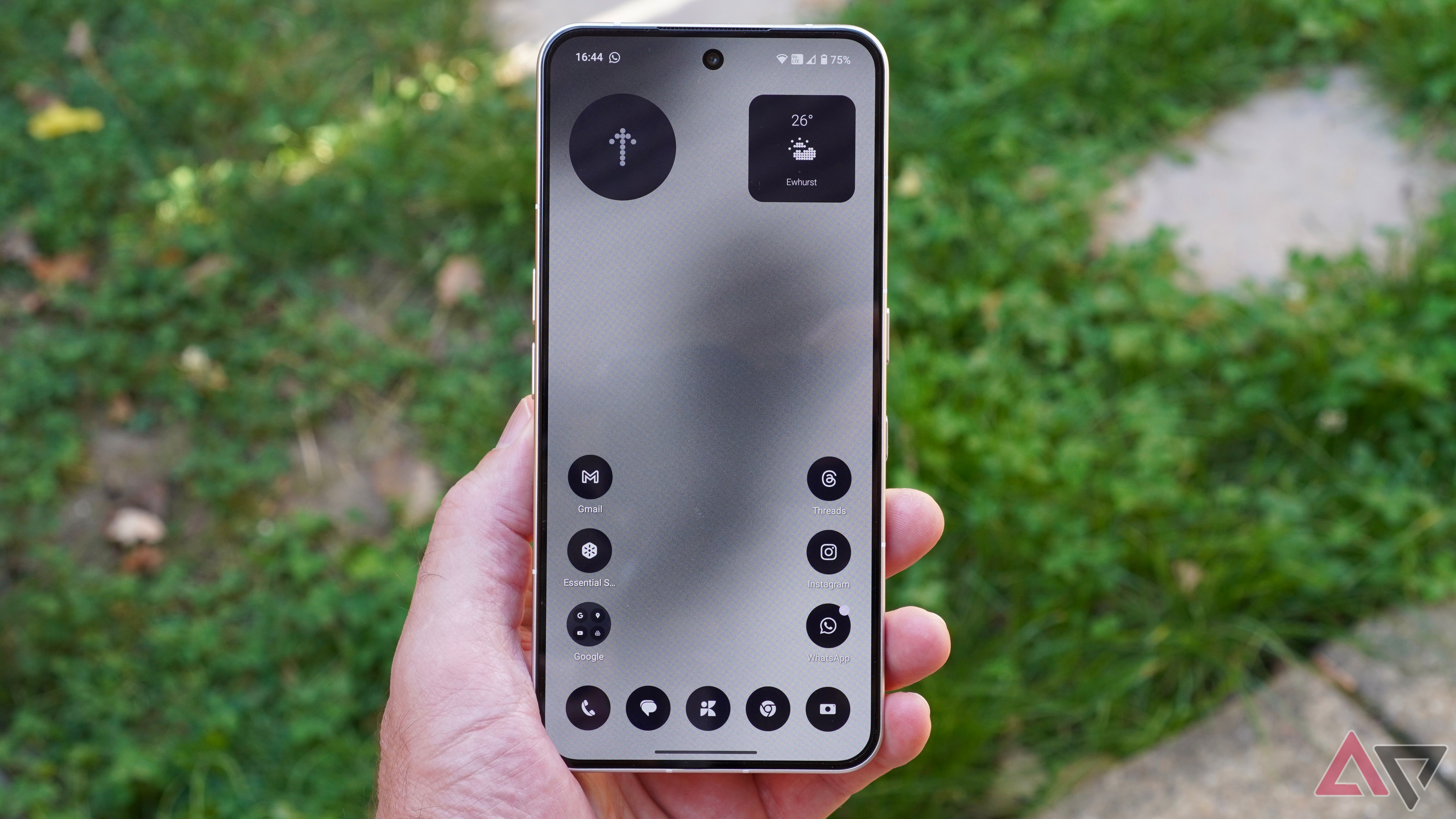 A person holding the Nothing Phone 3, with the Nothing OS 3.5 theme applied to the software