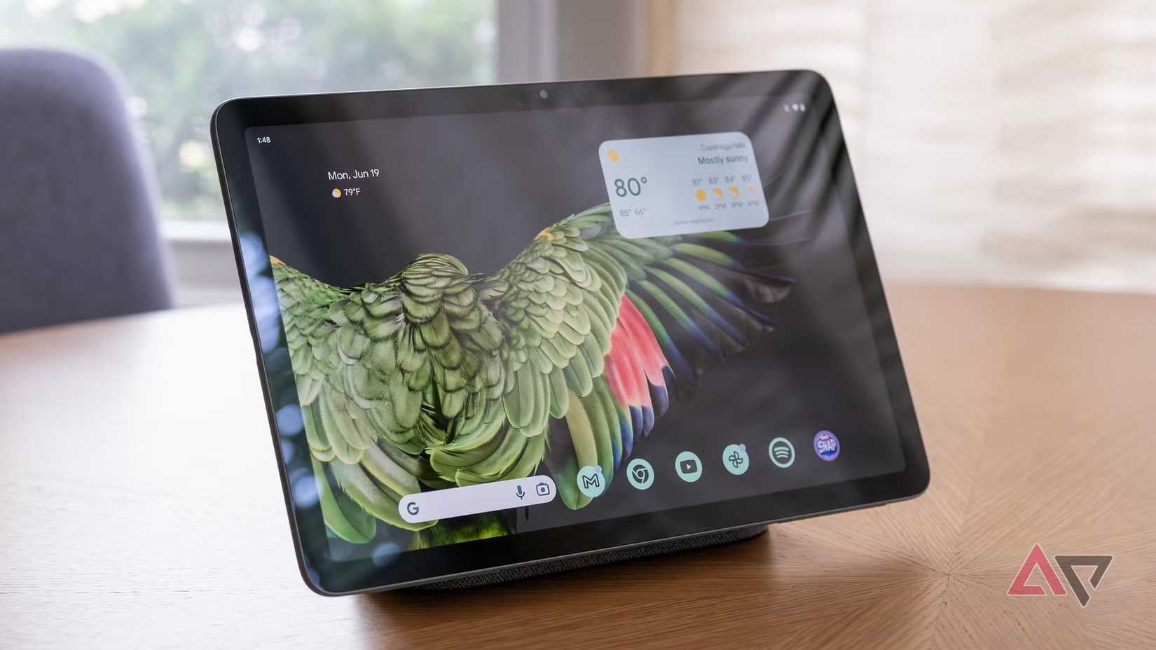 The Pixel Tablet sitting on its dock on a table.