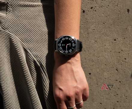The Samsung Galaxy Watch 8 Classic on a wrist in front of a concrete wall