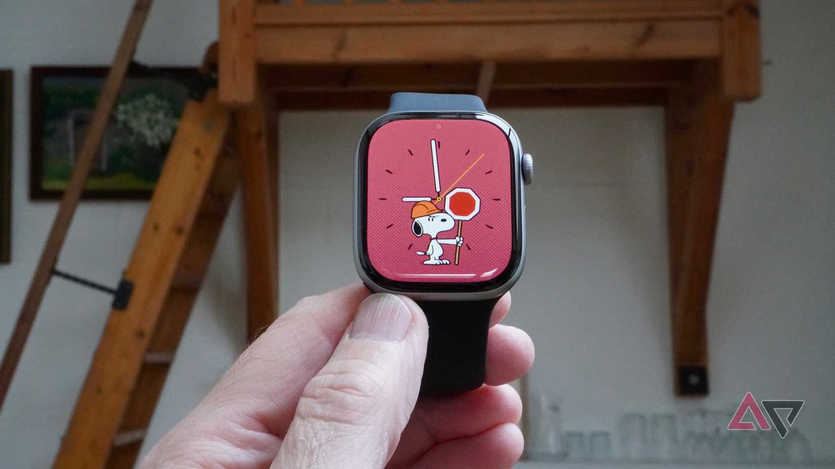 A person holding the Apple Watch Series 11 with the Snoopy watch face